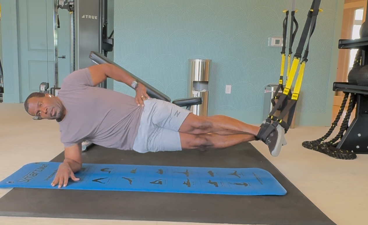 Coach E demonstrating side plank—suspension training after 50
